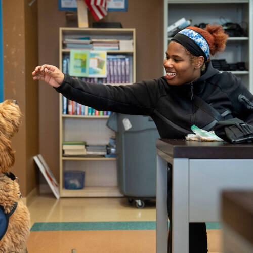 student given Beau the dog a treat